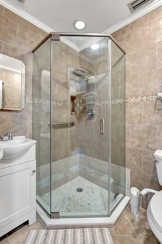 a bathroom with a shower a toilet and sink