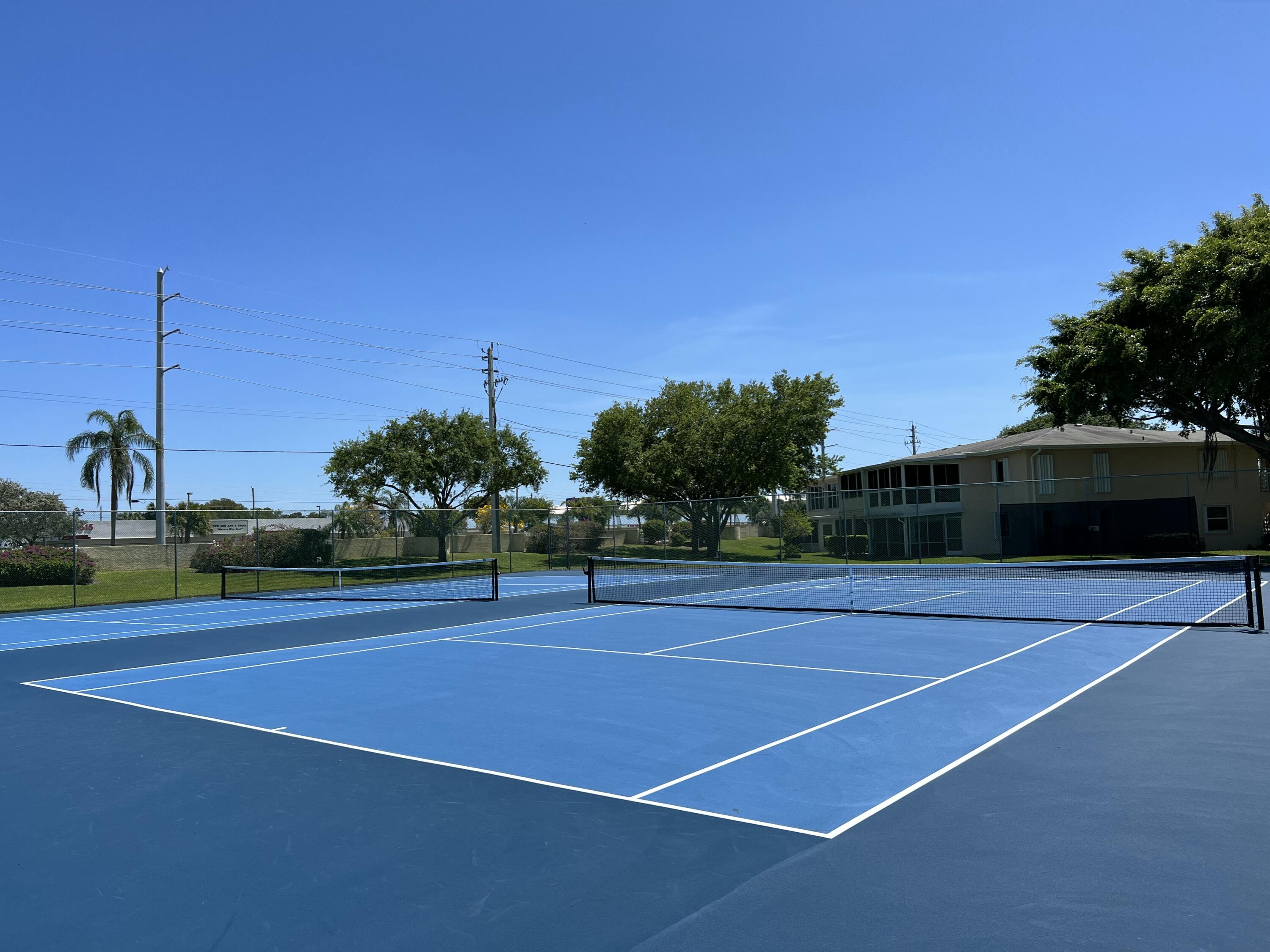 1710 Northwest 18th Avenue, Unit 204 Delray Beach, FL 33445 - Photo 19 of 21 a view of a tennis court