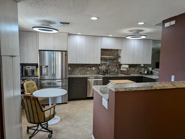 a kitchen with a refrigerator a sink and a stove