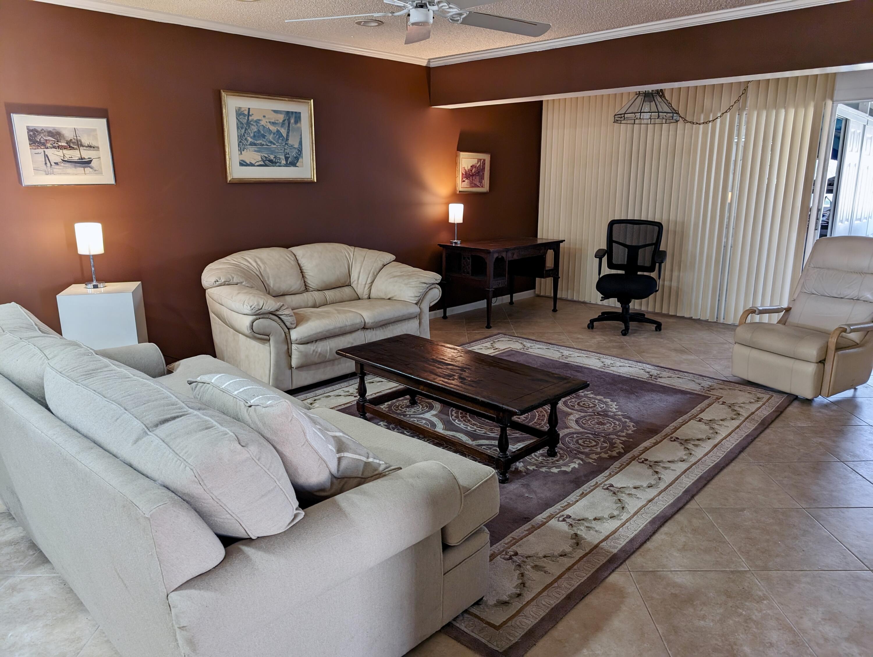 1710 Northwest 18th Avenue, Unit 204 Delray Beach, FL 33445 - Photo 8 of 21 a living room with furniture and a window