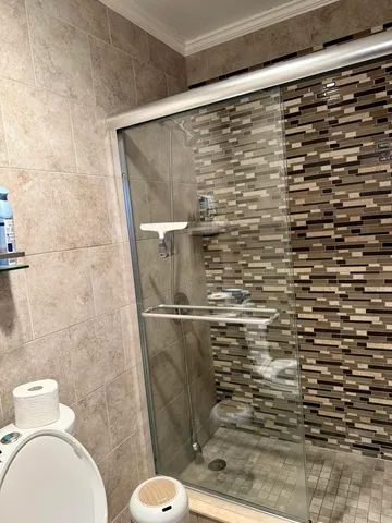 a bathroom with a toilet and a shower