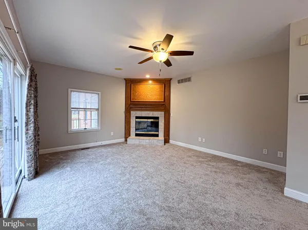a kitchen with granite countertop a stove a sink and a refrigerator