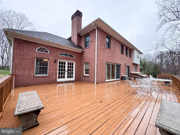 a view of a house with a big yard and large tree