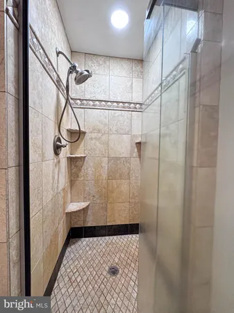 an empty room with fan and windows