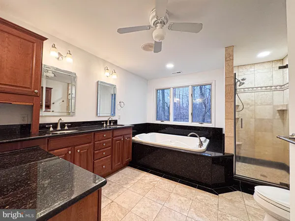 a bathroom with a sink a vanity a mirror and a bathtub