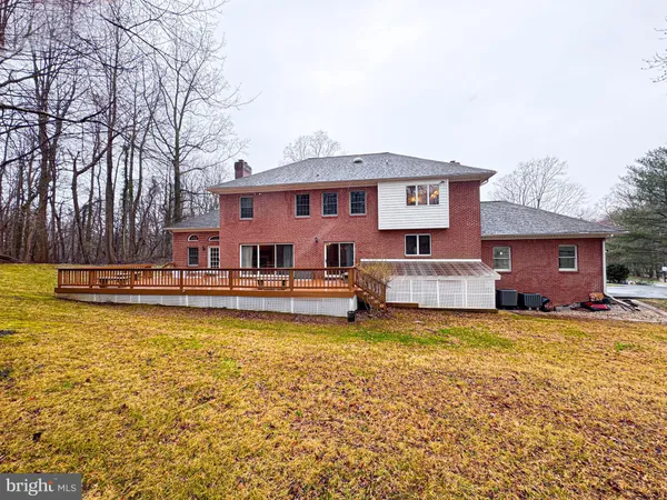 a view of a house with a yard and large tree