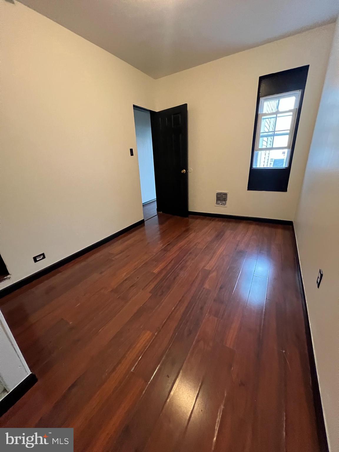 434 Birch Street Reading, PA 19604 - Photo 16 of 21 an empty room with wooden floor and windows