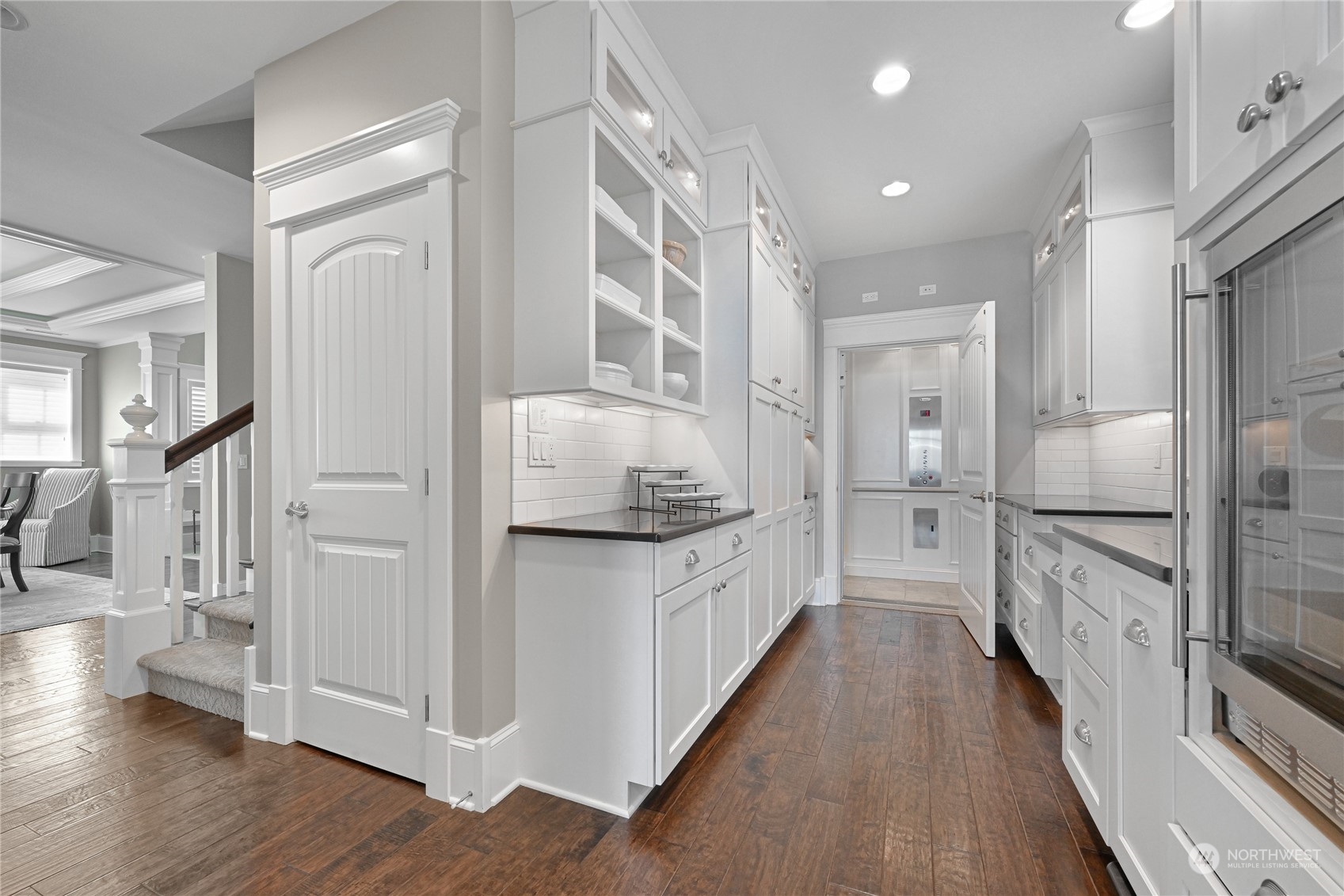 2015 Eldridge Avenue Bellingham, WA 98225 - Photo 18 of 40 a kitchen with white cabinets and wooden floor
