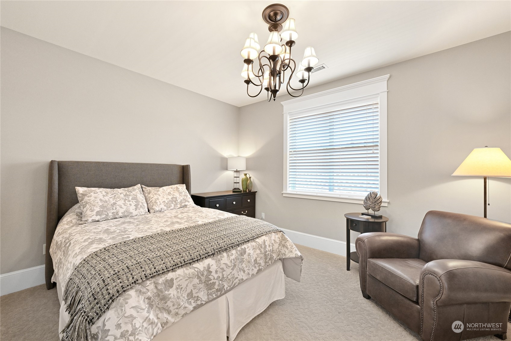 2015 Eldridge Avenue Bellingham, WA 98225 - Photo 31 of 40 a spacious bedroom with a bed and a chandelier