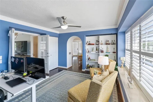 a living room with furniture a fireplace and a large window