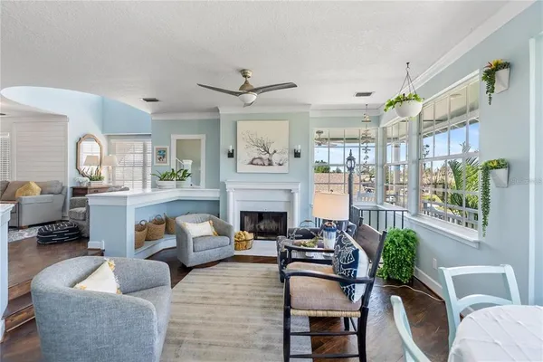 a living room with furniture a large window and a fireplace