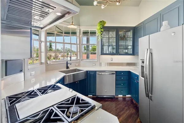 a kitchen with a refrigerator and a stove top oven