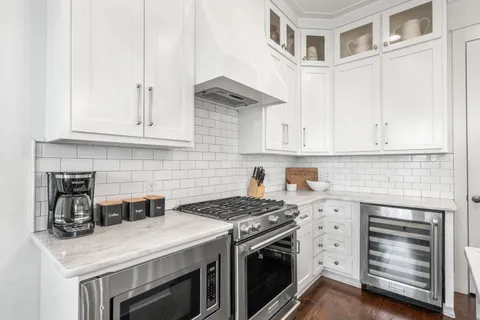 a kitchen with granite countertop a stove sink and cabinets