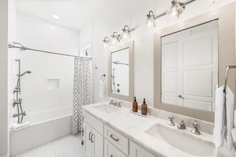 a bathroom with a granite countertop sink a mirror a shower and a bathtub