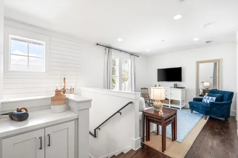 a living room with furniture and flat screen tv