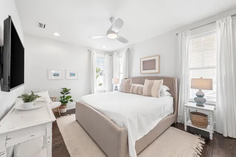 a bedroom with a large bed and a flat screen tv