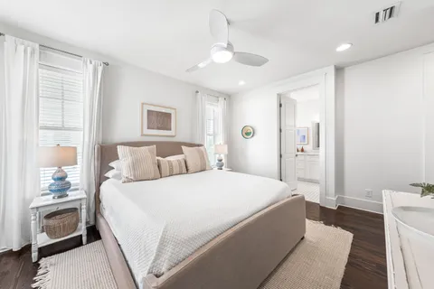 a spacious bedroom with a bed and a lamp