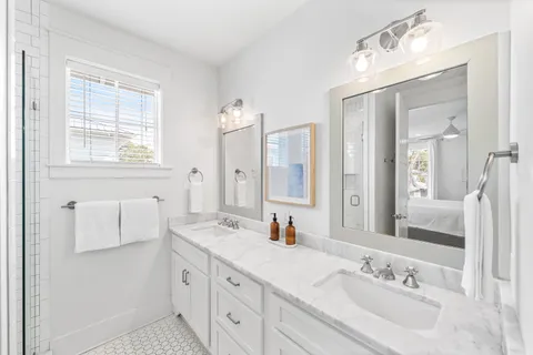 a bathroom with a double vanity sink mirror and