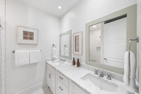 a bathroom with a double vanity sink mirror and double