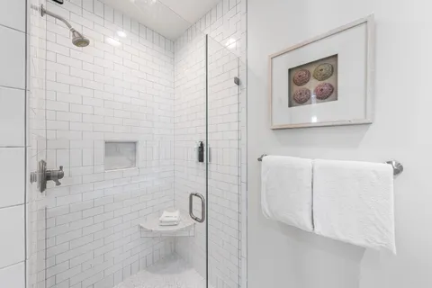 a bathroom with a toilet and a shower