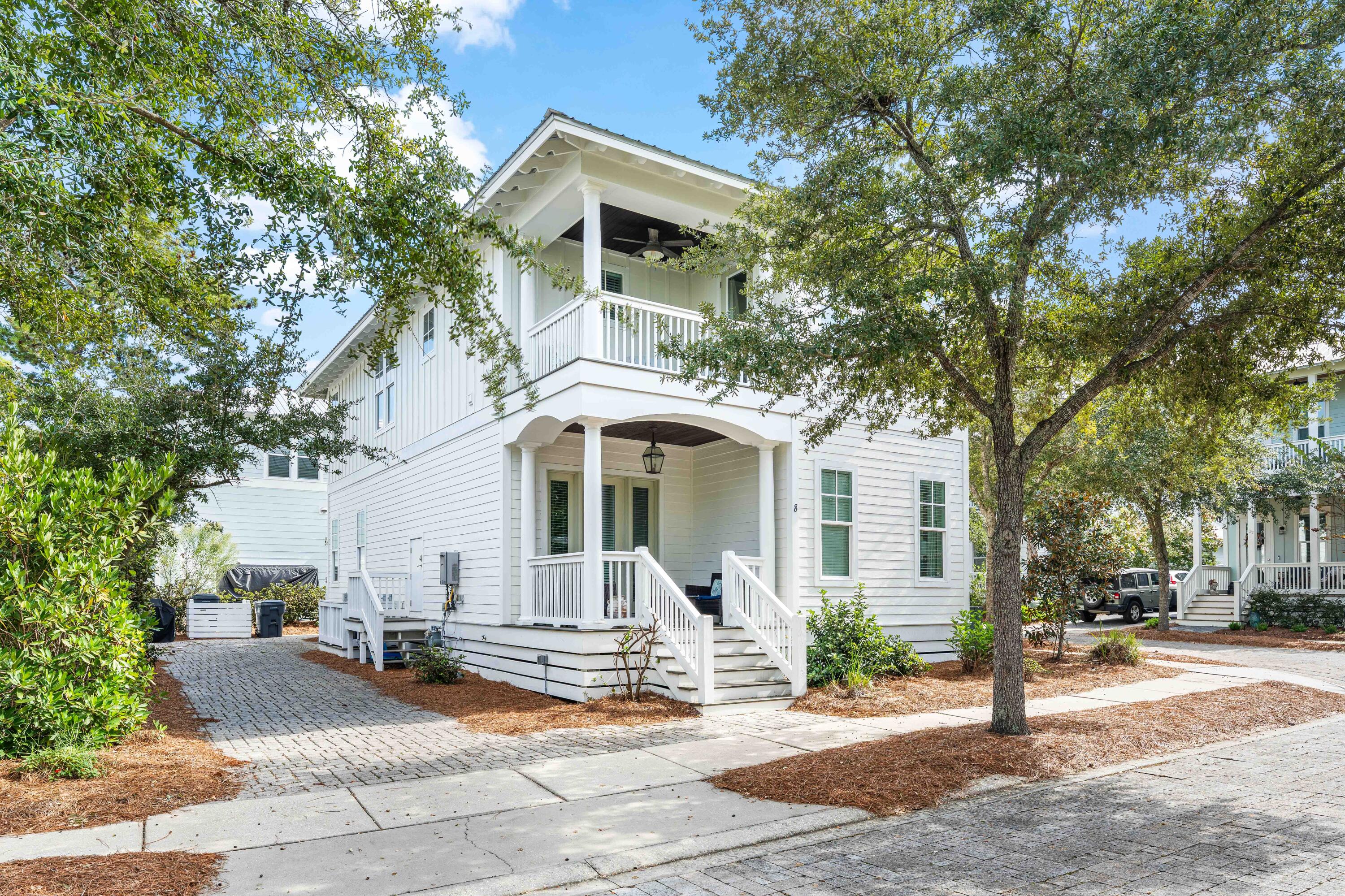 8 Hiker Street Santa Rosa Beach, FL 32459 - Photo 3 of 41 a view of a white house with large windows and a tree