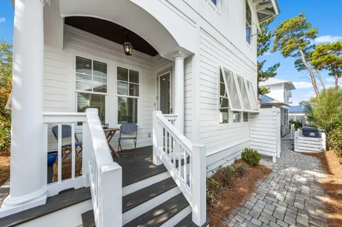 a view of front door of house with stairs