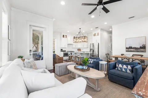 a living room with furniture and a view of kitchen