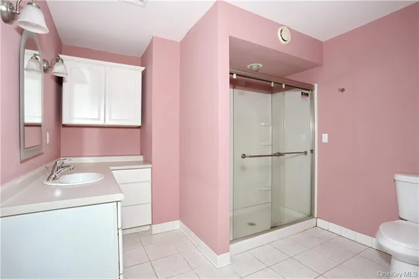 an empty room with a window and a ceiling fan