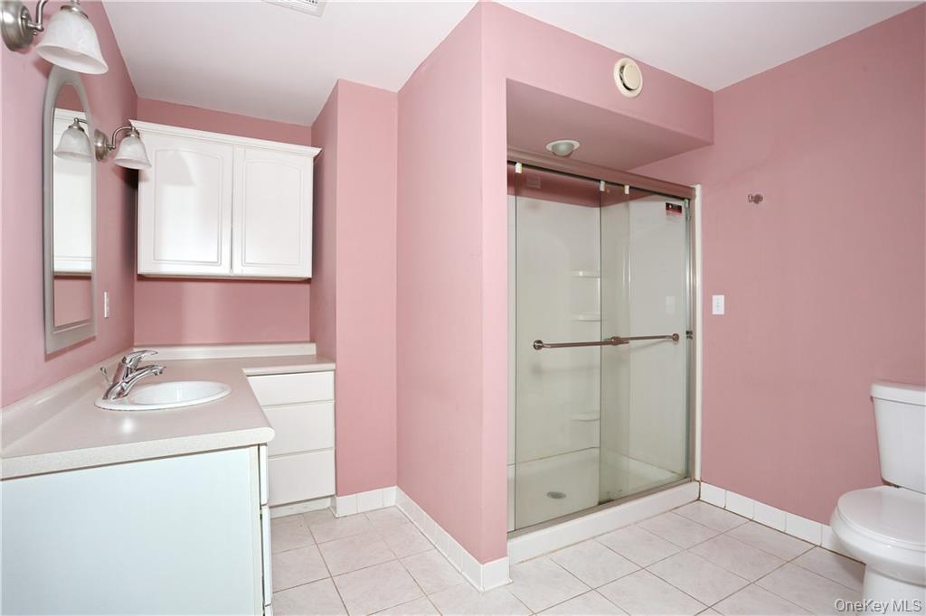 80 Old Quaker Hill Road, Unit 2 Monroe, NY 10950 - Photo 13 of 20 a bathroom with a granite countertop sink toilet and shower