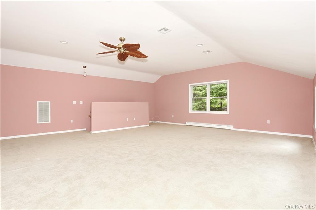 80 Old Quaker Hill Road, Unit 2 Monroe, NY 10950 - Photo 14 of 20 an empty room with a window and a ceiling fan