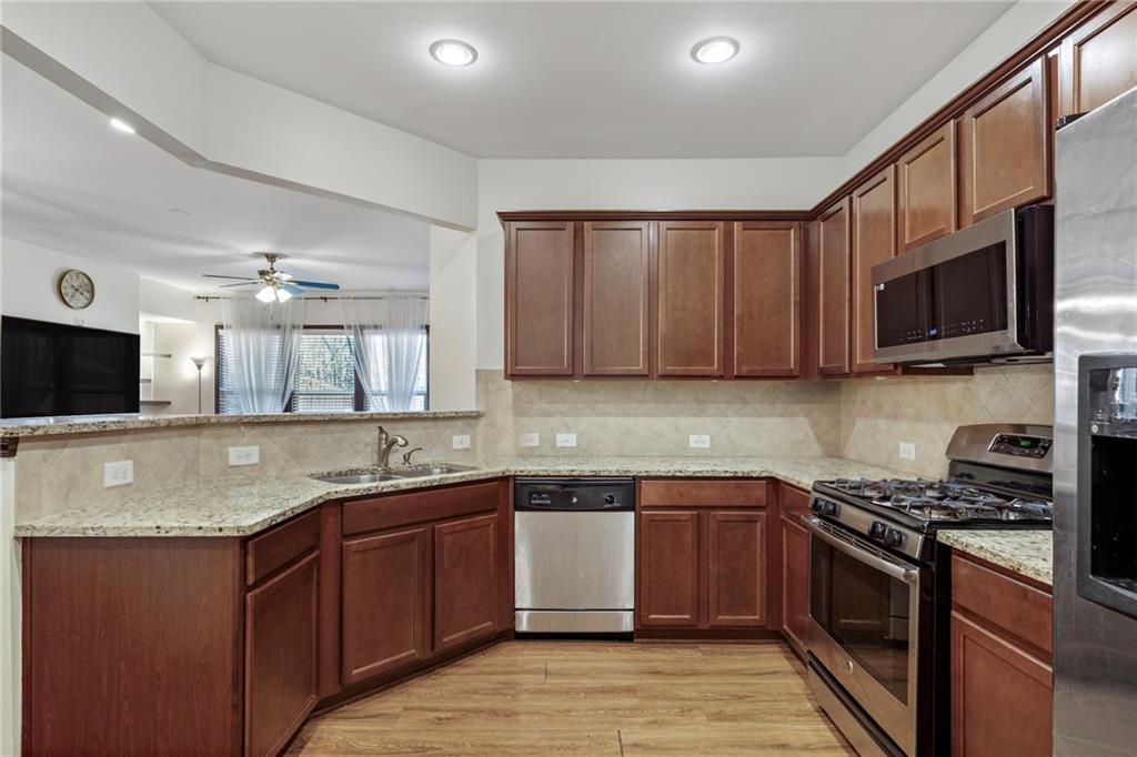 4430 Cedar Bridge Walk Suwanee, GA 30024 - Photo 13 of 33 a kitchen with a sink stove top oven and refrigerator