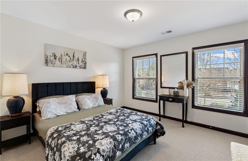 4430 Cedar Bridge Walk Suwanee, GA 30024 - Photo 24 of 33 a bedroom with a large bed and a window