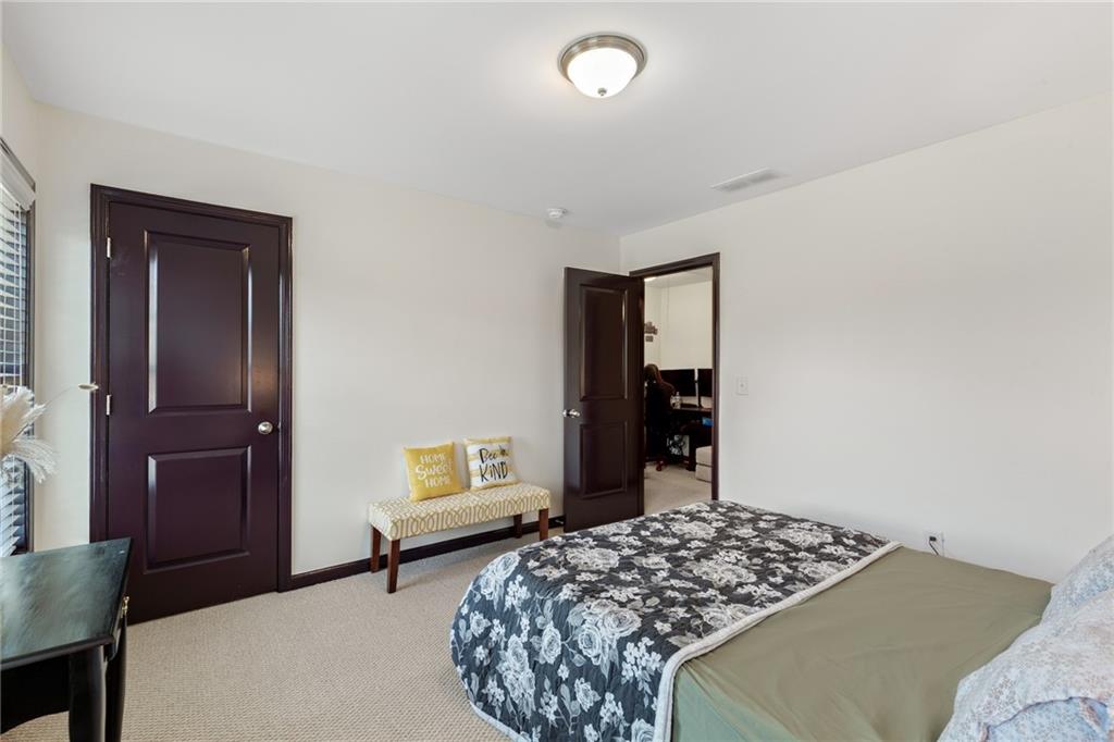 4430 Cedar Bridge Walk Suwanee, GA 30024 - Photo 26 of 33 a bedroom with a bed and a dresser