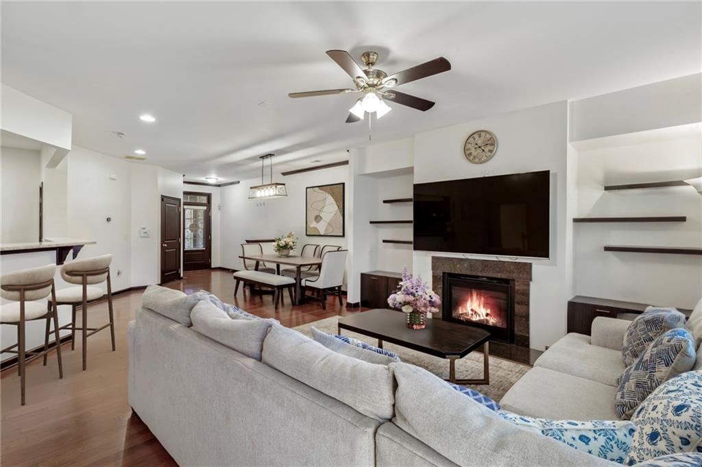 4430 Cedar Bridge Walk Suwanee, GA 30024 - Photo 7 of 33 a living room with furniture a flat screen tv and a fireplace