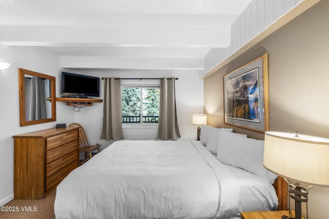 a bedroom with a bed and window