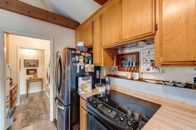 a kitchen with a refrigerator and a sink