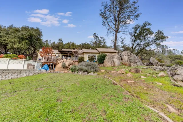 a front view of a house with swimming pool having outdoor seating