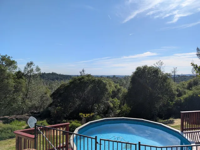 a view of a balcony with furniture and yard