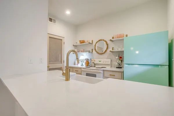 a kitchen with sink a stove and refrigerator