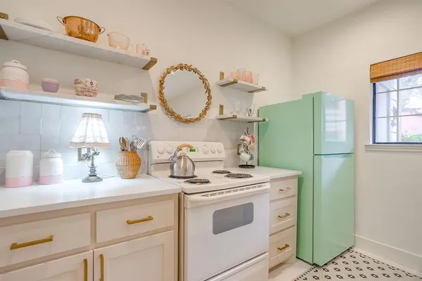 a kitchen with a refrigerator sink and cabinets