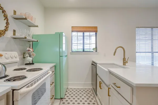 a kitchen with a sink stove and refrigerator