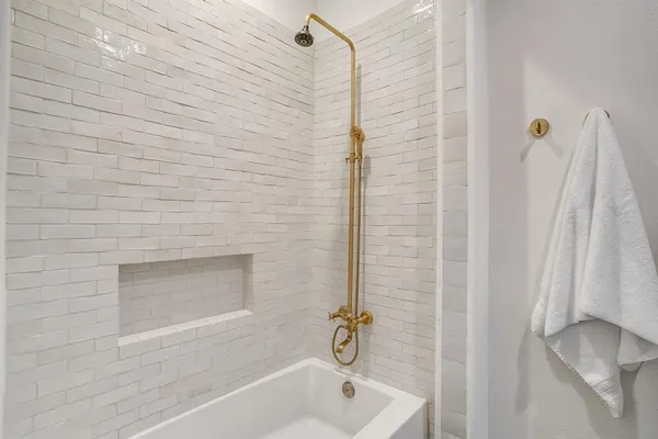 a bathroom with a shower and a tub