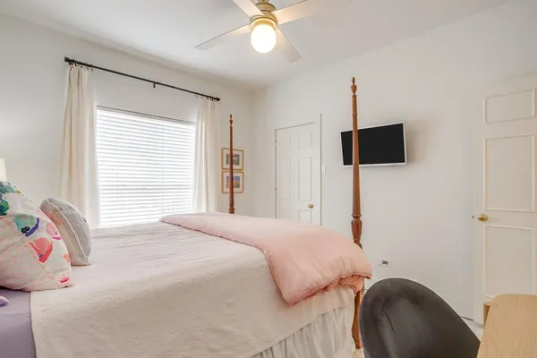 a bedroom with a bed and a flat screen tv