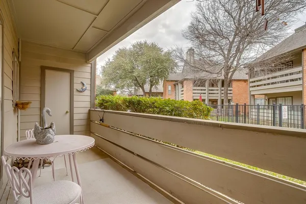 a view of a patio with table and chairs and potted plants