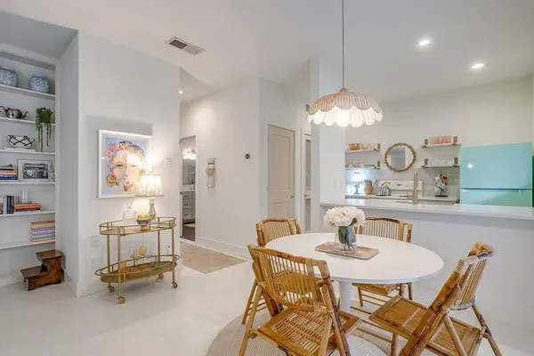 a dining room with furniture and a chandelier