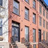 a front view of a brick building with many windows
