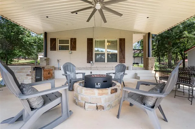 a building outdoor space with patio furniture and potted plants
