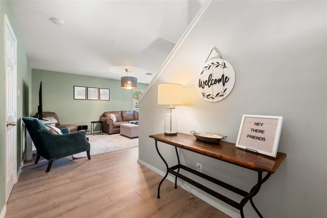 a living room with furniture and a wooden floor