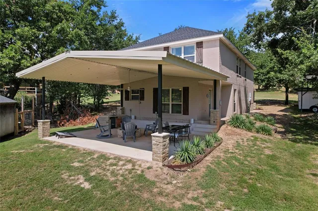 a view of a patio with table and chairs under an umbrella