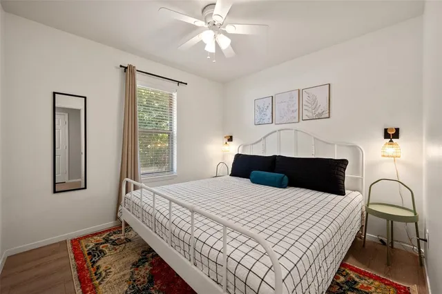 a bedroom with a large bed and a window